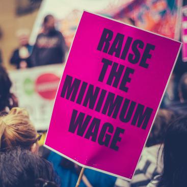 Poster that reads "raise the minimum wage"