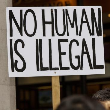 Poster that says "No Human is Illegal"